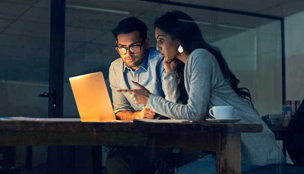 Man and woman working on laptop