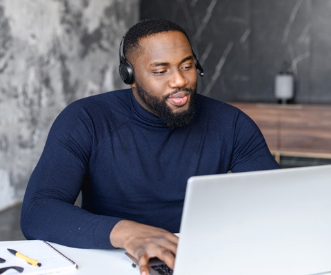 man on laptop with headset